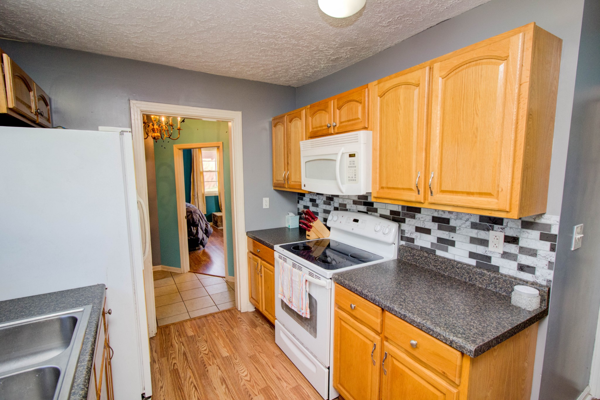 1409 5th Avenue West Springfield, TN 37172 - Photo 18 of 41 a kitchen with stainless steel appliances granite countertop a sink stove and refrigerator