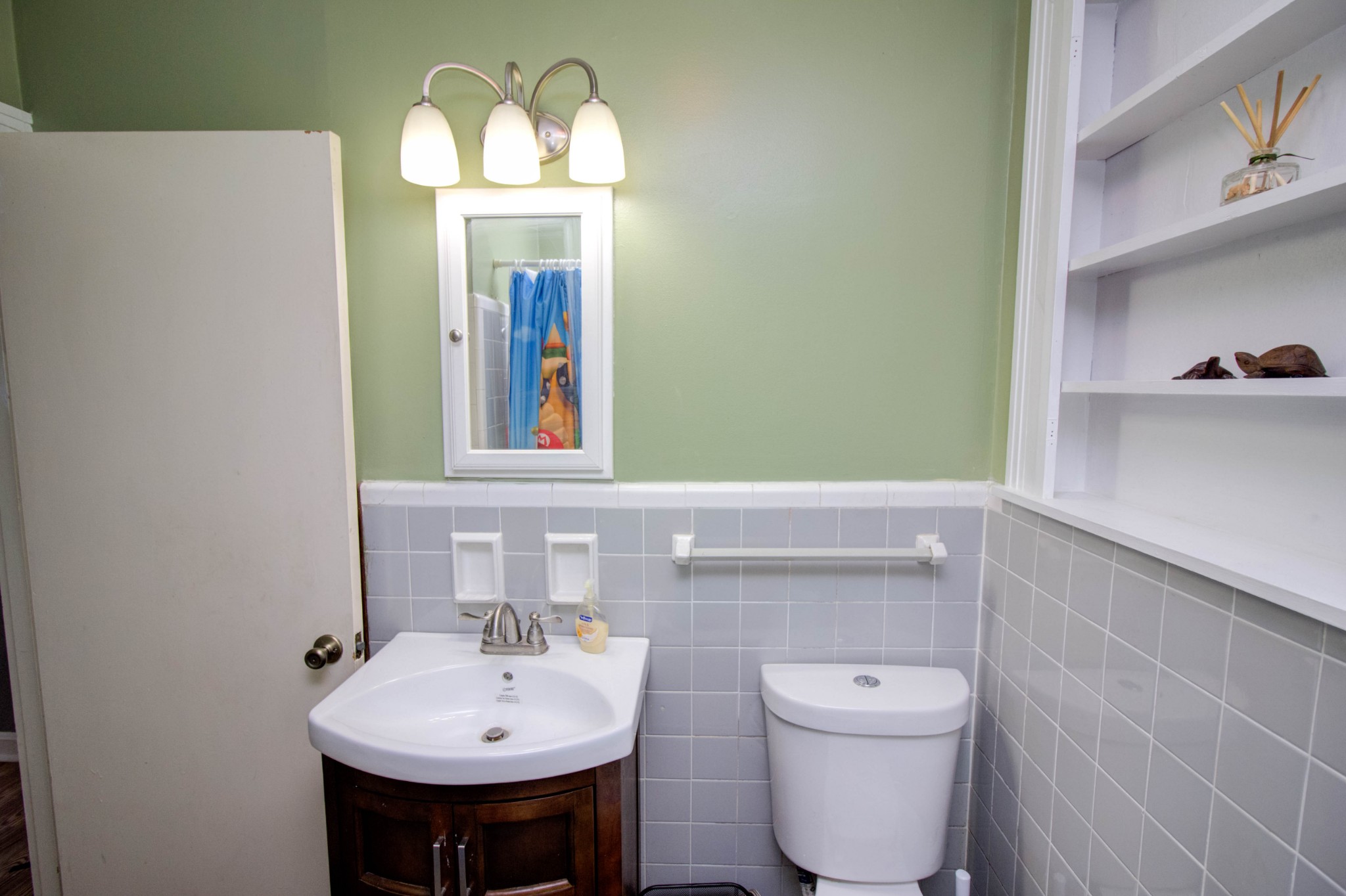 1409 5th Avenue West Springfield, TN 37172 - Photo 10 of 41 a bathroom with a toilet sink and mirror