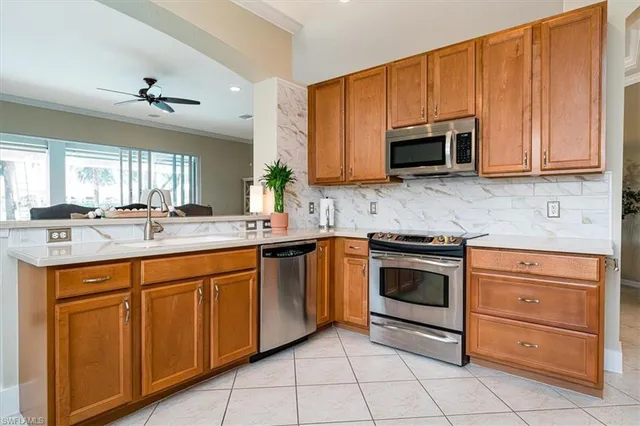 a kitchen with stainless steel appliances granite countertop a sink and cabinets