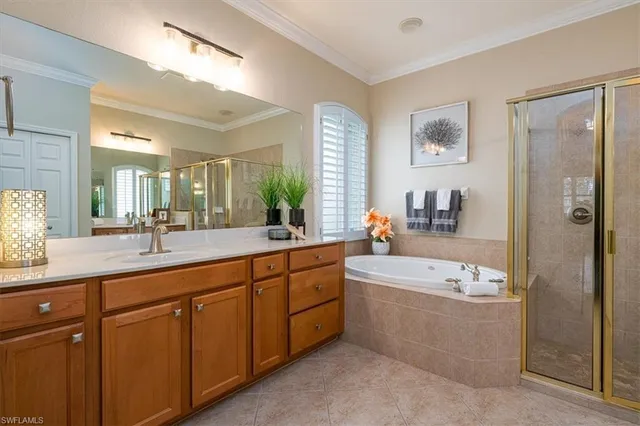 a spacious bathroom with a double vanity sink large mirror and a bathtub