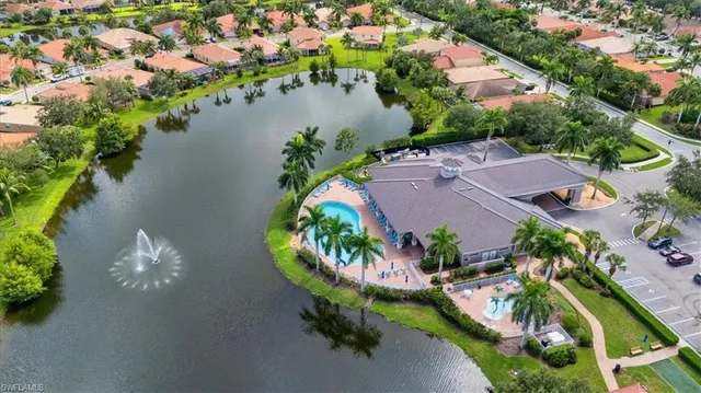 an aerial view of a house with a garden and lake view