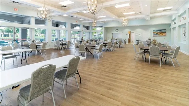 a view of a dining hall with lots of furniture and a large window