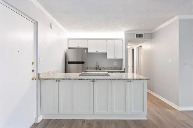 a kitchen with stainless steel appliances a sink and a refrigerator