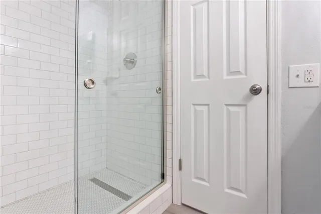 a bathroom with a glass shower door