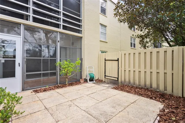 a backyard of a house with potted plants