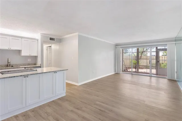 a view of kitchen with granite countertop cabinets and wooden floor
