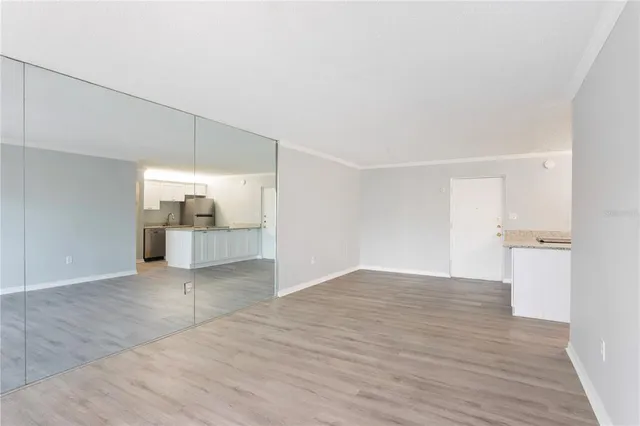 a view of empty room with wooden floor
