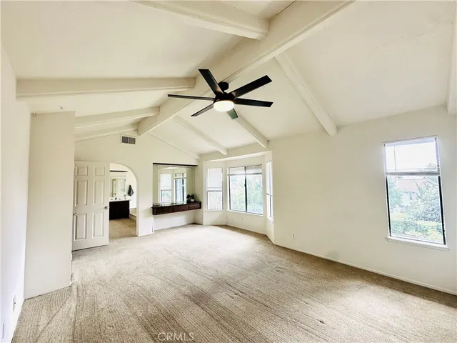 a view of a livingroom with a kitchen and a ceiling fan