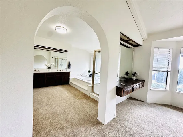 a view of kitchen with stainless steel appliances refrigerator stove and wooden floor
