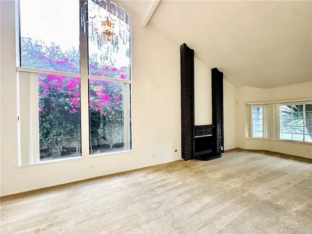 an empty room with large windows
