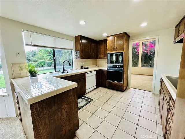 a kitchen with stainless steel appliances a sink stove and refrigerator