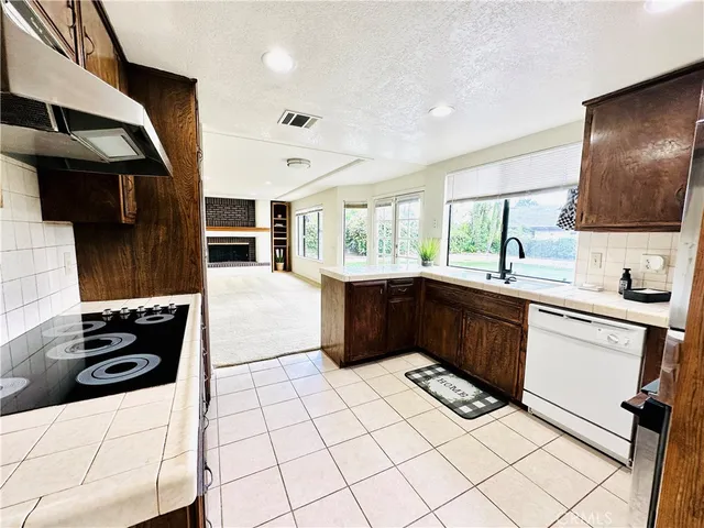 a kitchen with stainless steel appliances a stove a sink and a microwave