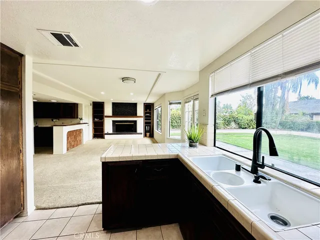 a kitchen with a sink appliances and a large window