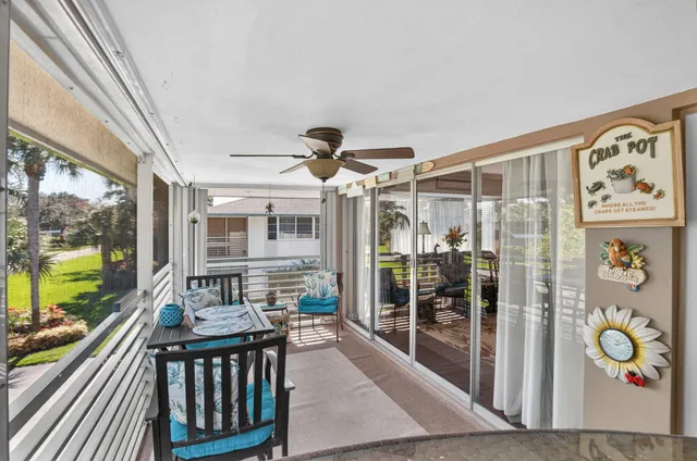 a view of a balcony with furniture and wooden floor