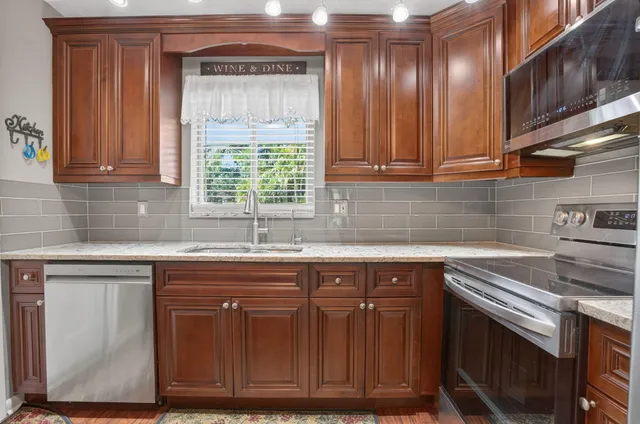 a kitchen with cabinets and window