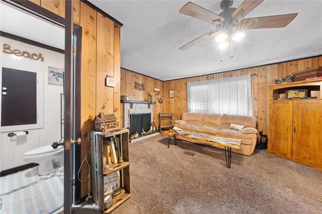 a spacious bedroom with a bed and a flat tv screen on dresser