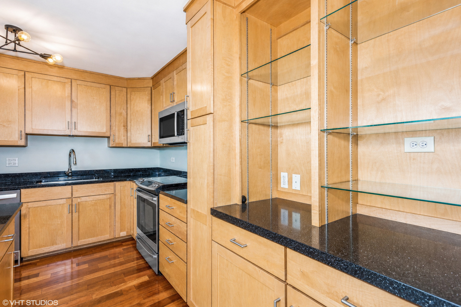 655 West Irving Park Road, Unit 1903 Chicago, IL 60613 - Photo 9 of 22 a kitchen with stainless steel appliances granite countertop a sink and cabinets