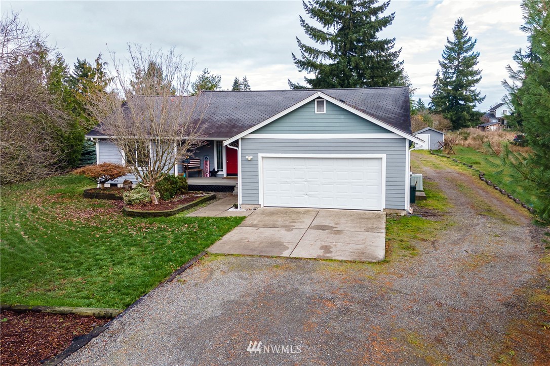 18036 Daryl Lane Southwest Rochester, WA 98579 - Photo 1 of 40 a front view of a house with a yard and garage
