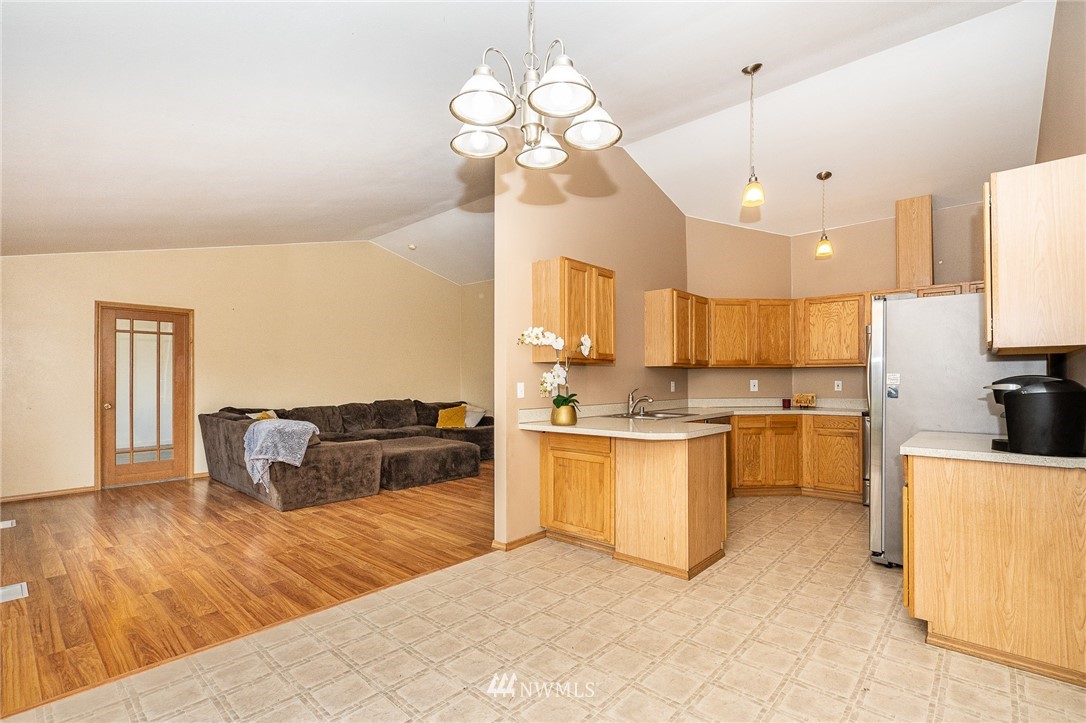 18036 Daryl Lane Southwest Rochester, WA 98579 - Photo 16 of 40 a large kitchen with kitchen island granite countertop a stove a sink a oven and a view of living room