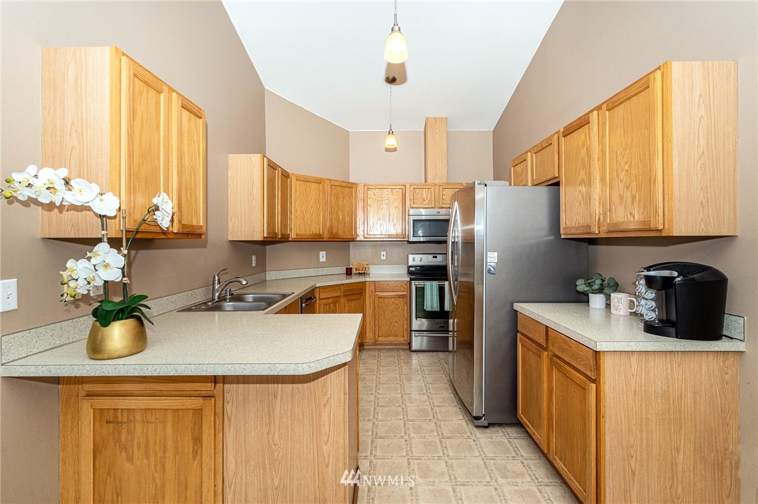18036 Daryl Lane Southwest Rochester, WA 98579 - Photo 17 of 40 a kitchen with sink a refrigerator and cabinets