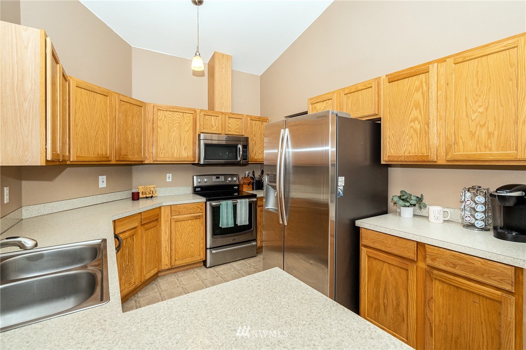 18036 Daryl Lane Southwest Rochester, WA 98579 - Photo 18 of 40 a kitchen with stainless steel appliances a refrigerator sink and microwave