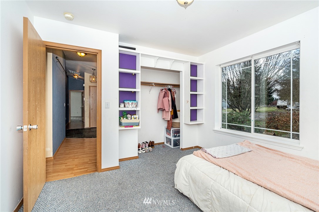 18036 Daryl Lane Southwest Rochester, WA 98579 - Photo 21 of 40 a bedroom with a bed and a large window with the outer view