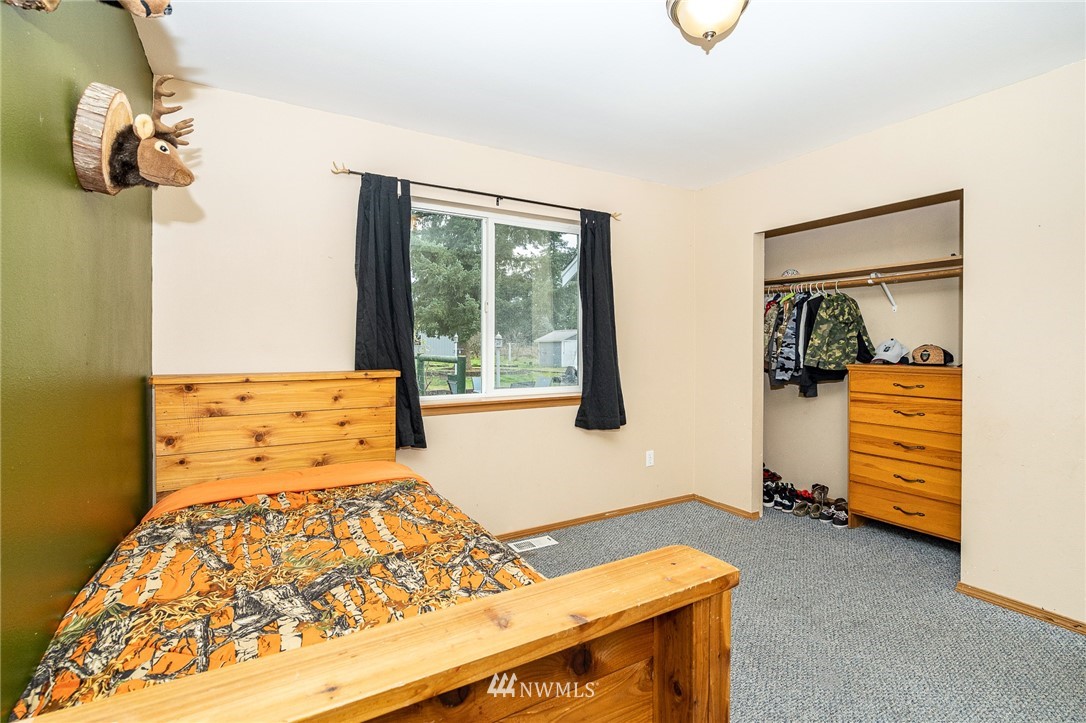18036 Daryl Lane Southwest Rochester, WA 98579 - Photo 24 of 40 a bedroom with a bed and dresser
