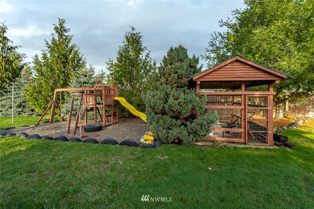 18036 Daryl Lane Southwest Rochester, WA 98579 - Photo 30 of 40 a view of a wooden deck and a yard with plants and large trees