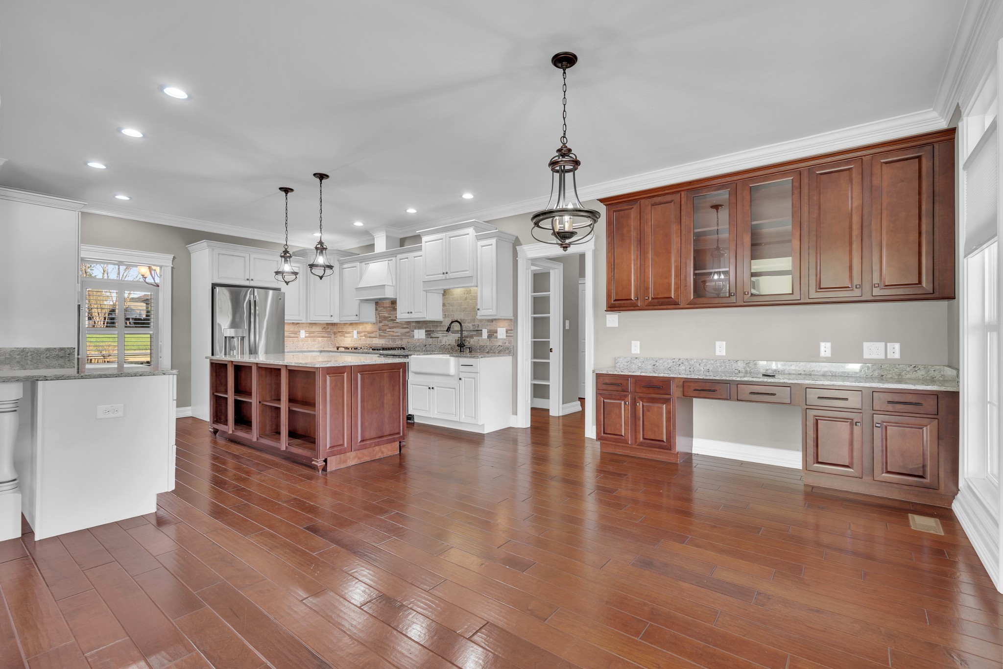 254 Gray Hawk Trail Clarksville, TN 37043 - Photo 11 of 29 a large kitchen with stainless steel appliances granite countertop a large center island a stove a refrigerator cabinets and living room view