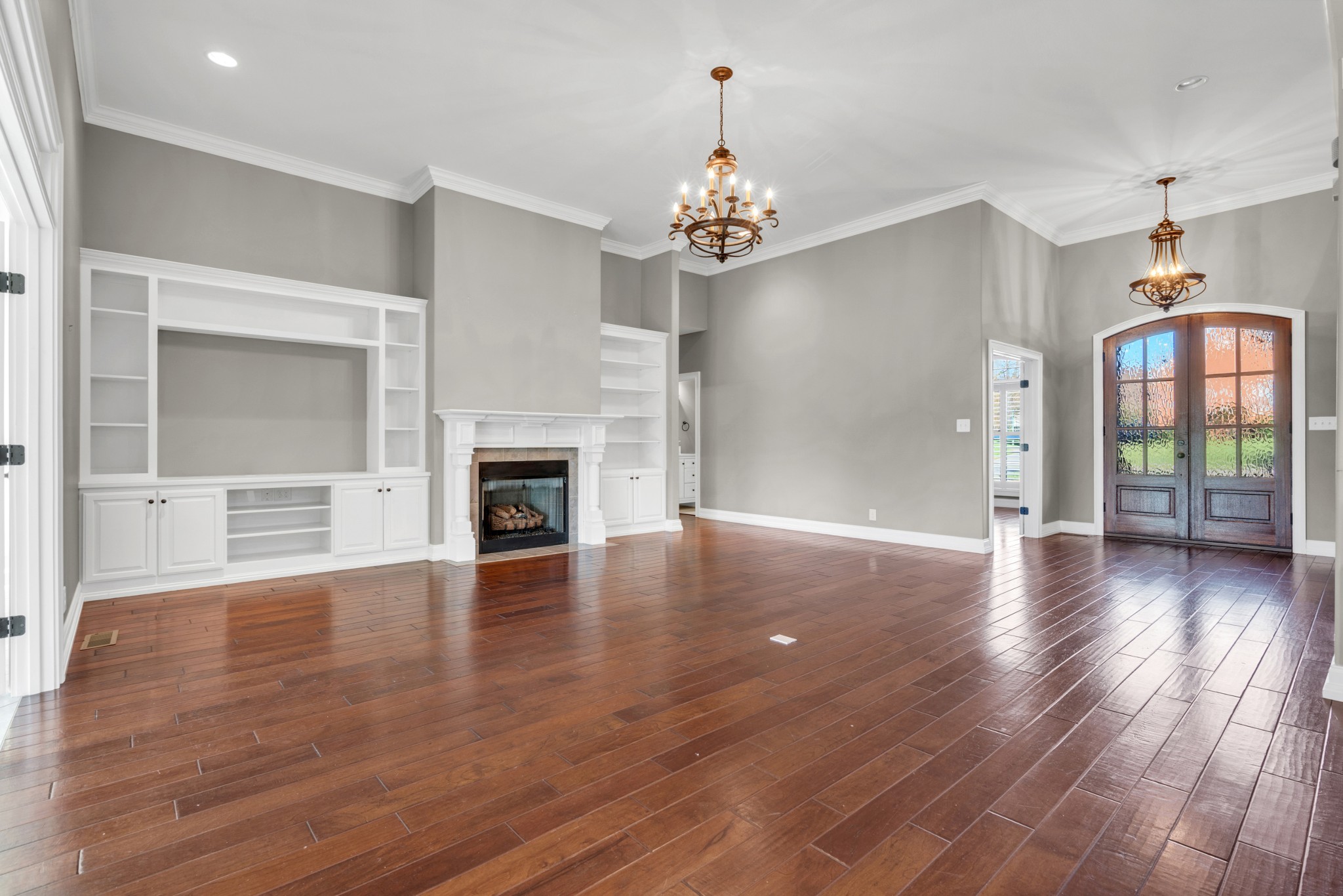 254 Gray Hawk Trail Clarksville, TN 37043 - Photo 8 of 29 an empty room with wooden floor fireplace and windows