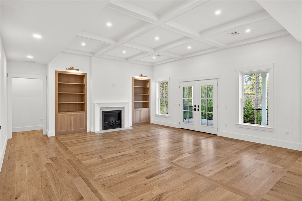 132 Great Western Road Harwich, MA 02645 - Photo 3 of 42 an empty room with wooden floor fireplace and windows