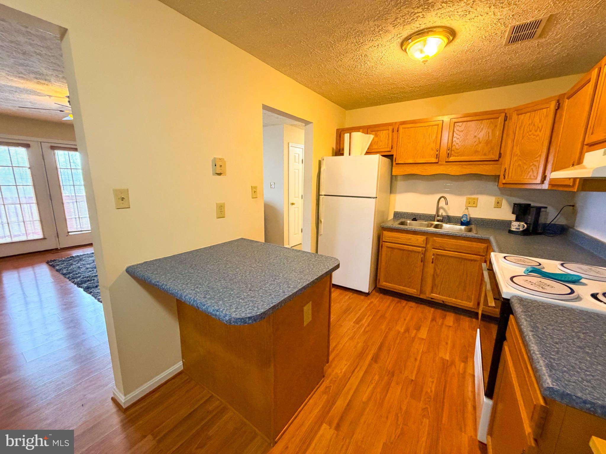 1292 South Ox Road, Unit F9 Woodstock, VA 22664 - Photo 5 of 19 Cozy kitchen with warm wooden accents.