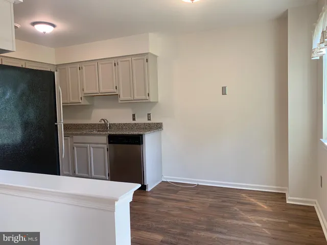 a kitchen with stainless steel appliances granite countertop a refrigerator stove and sink