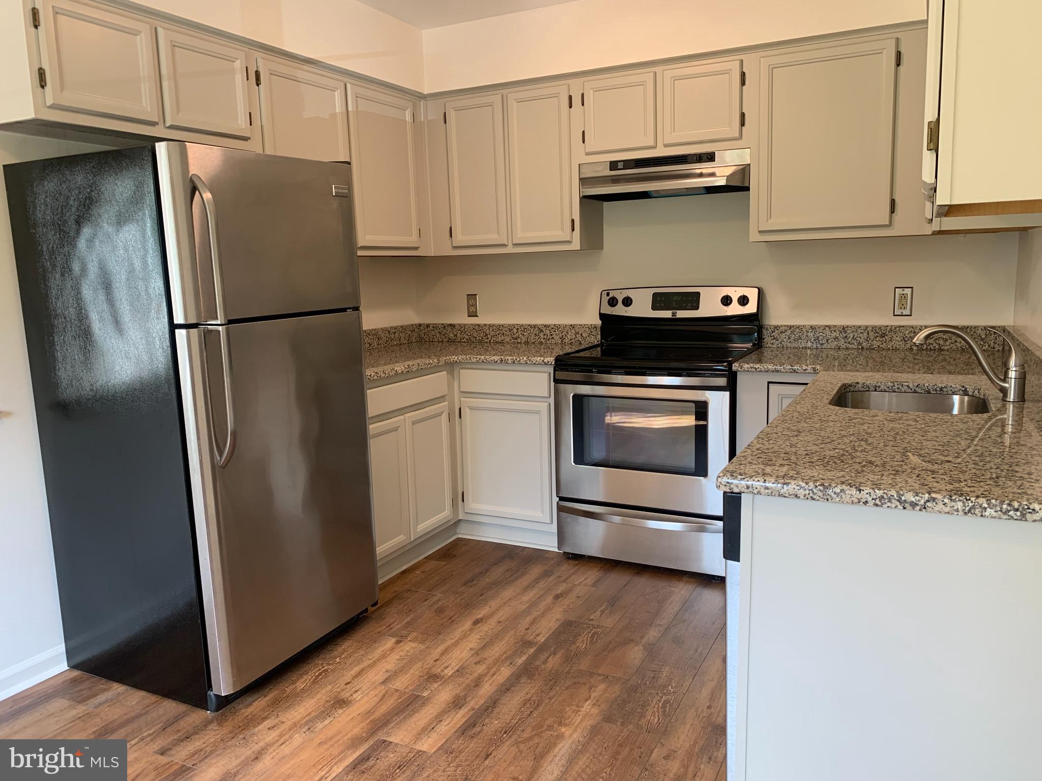 214 Christopher Place, Unit 214 Chalfont, PA 18914 - Photo 14 of 27 a kitchen with stainless steel appliances granite countertop a refrigerator stove and sink