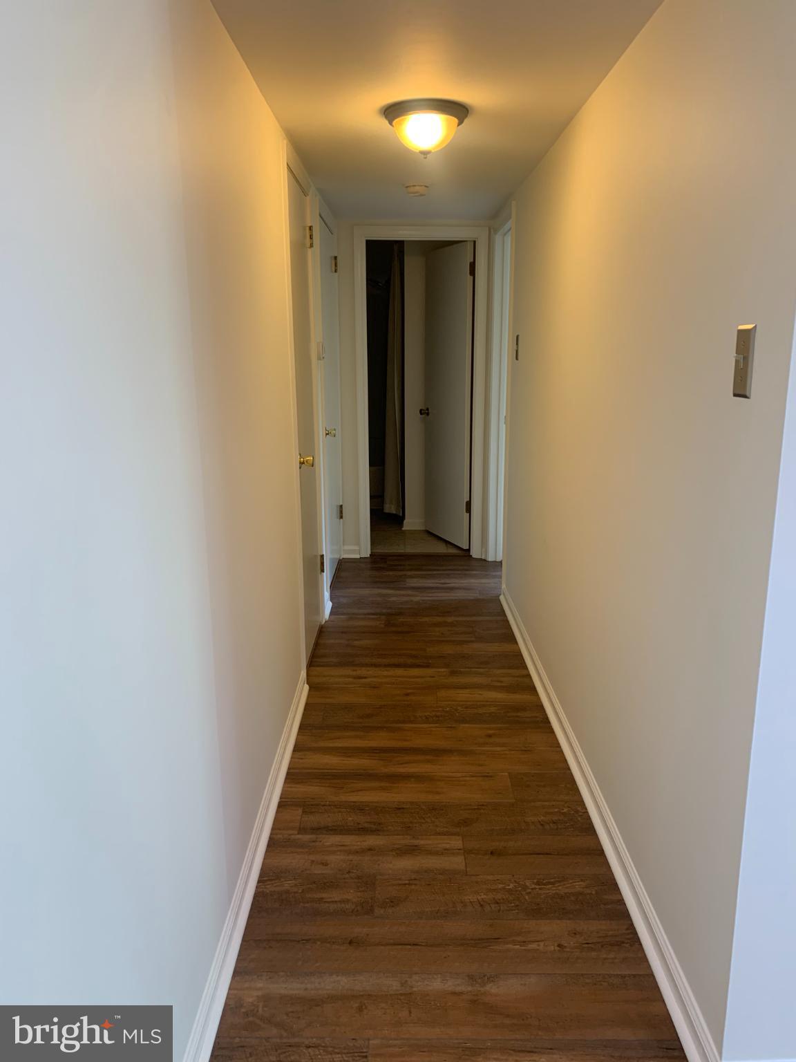 214 Christopher Place, Unit 214 Chalfont, PA 18914 - Photo 16 of 27 a view of a hallway with wooden floor