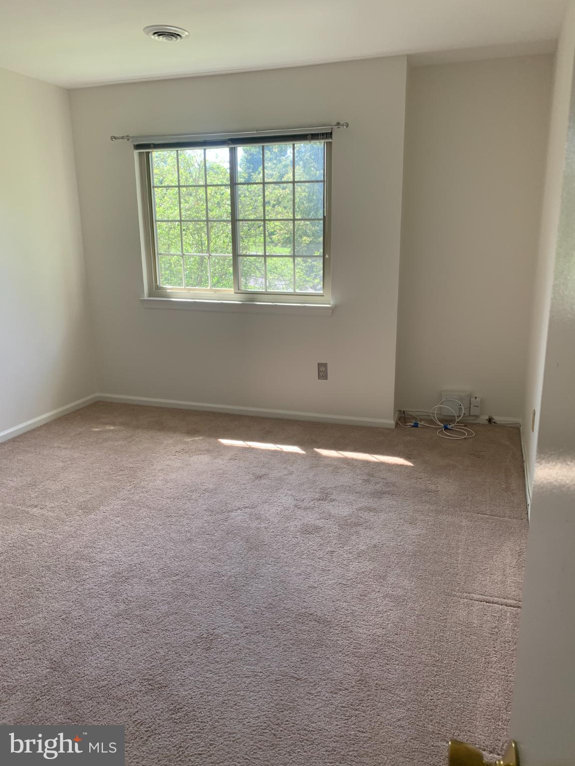 214 Christopher Place, Unit 214 Chalfont, PA 18914 - Photo 18 of 27 an empty room with a window