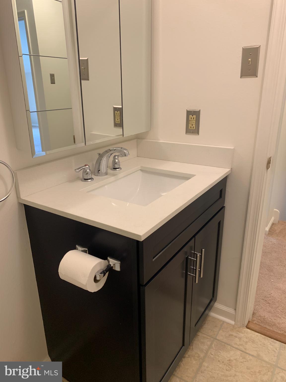 214 Christopher Place, Unit 214 Chalfont, PA 18914 - Photo 22 of 27 a bathroom with a sink and a mirror