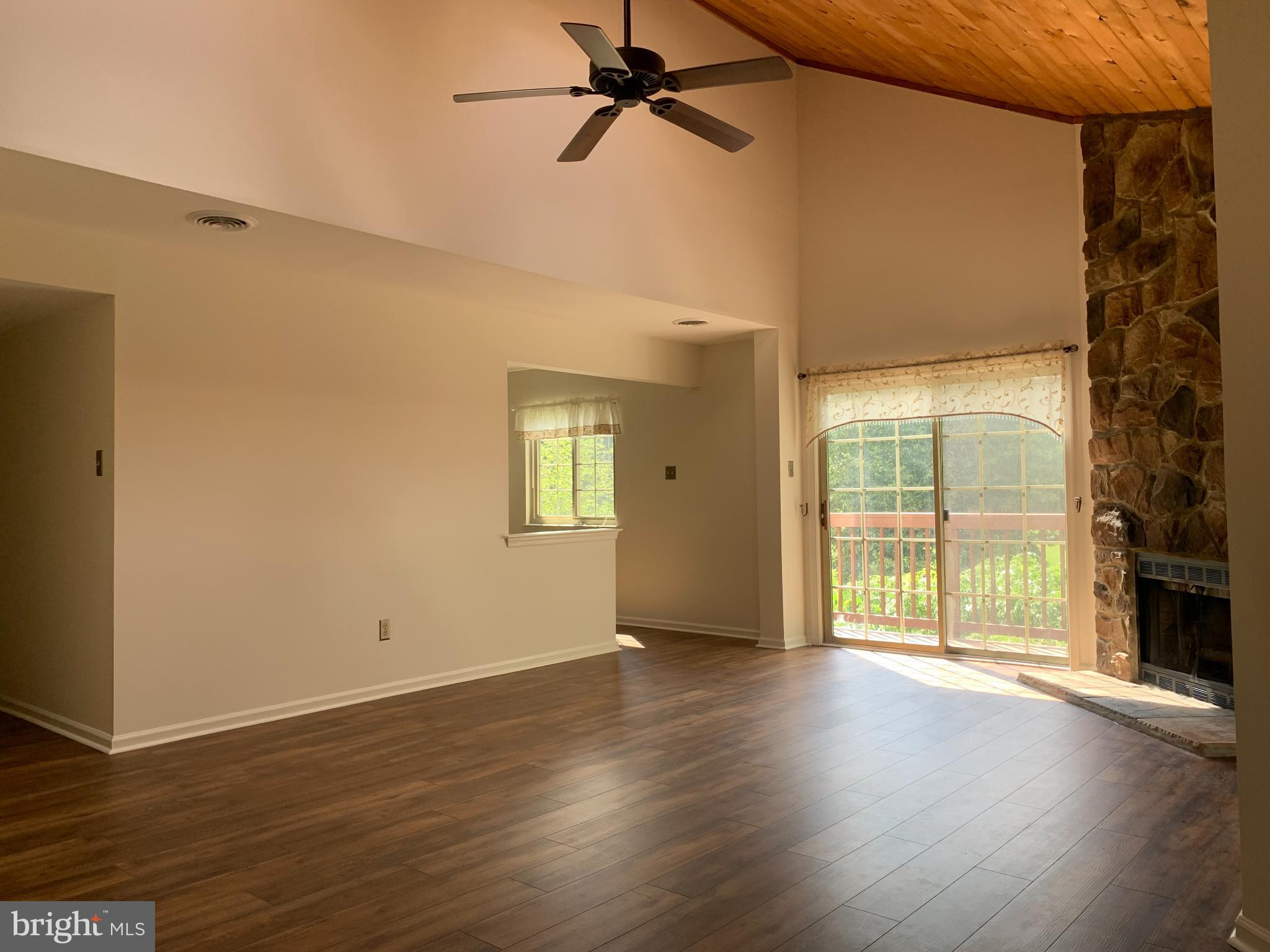 214 Christopher Place, Unit 214 Chalfont, PA 18914 - Photo 5 of 27 an empty room with wooden floor and windows