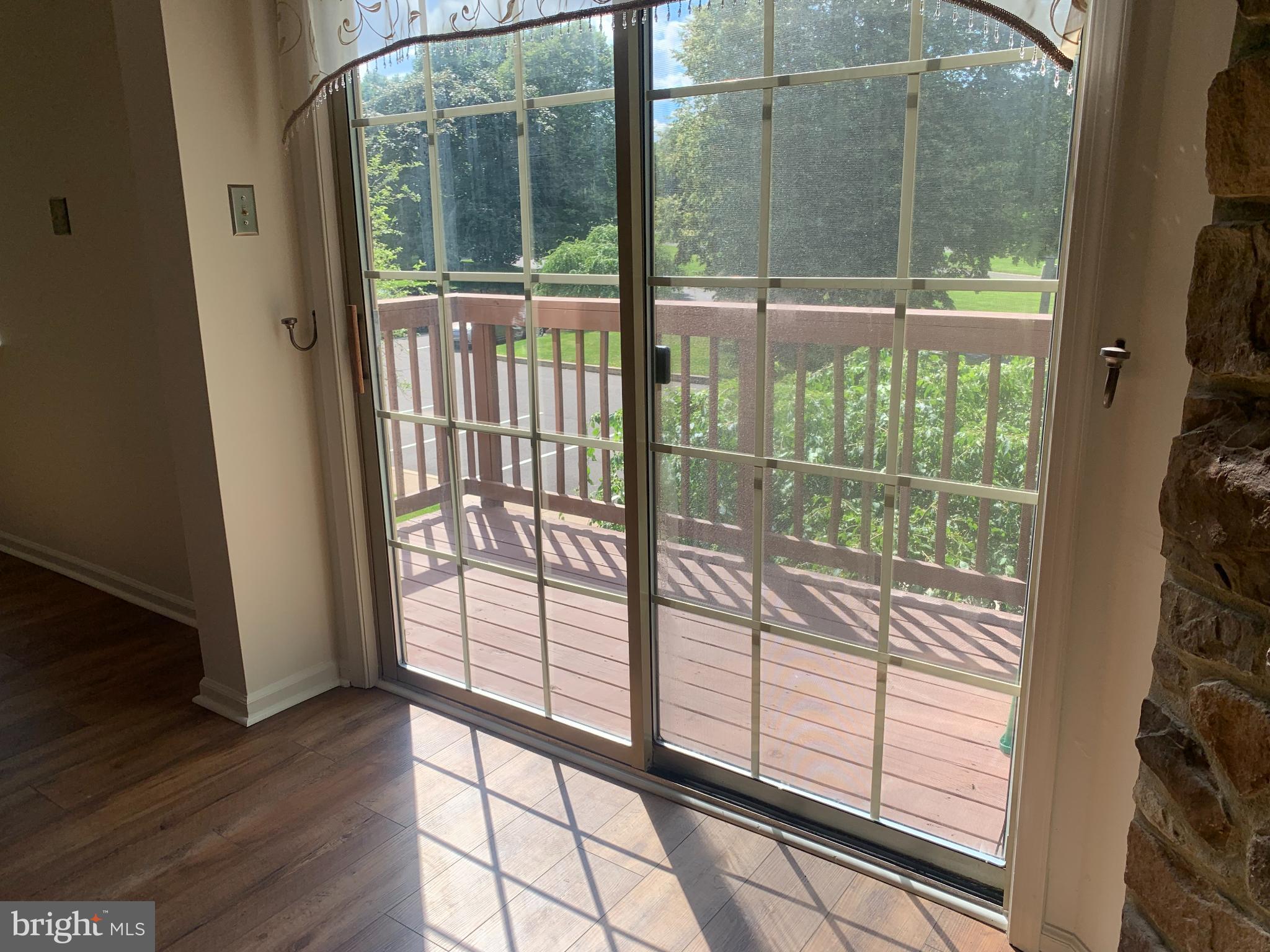 214 Christopher Place, Unit 214 Chalfont, PA 18914 - Photo 9 of 27 a view of a glass door with a porch