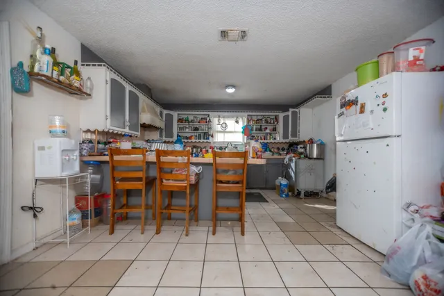 a dining room with furniture and a chandelier