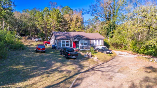 a view of a house with wooden fence