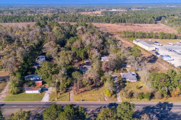 an aerial view of lake residential house with swimming pool and green space
