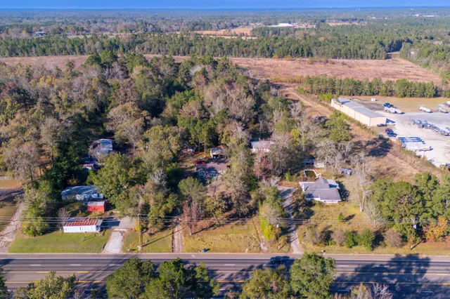 an aerial view of lake residential house with swimming pool and green space