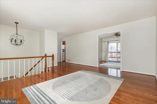 a view of a hallway with wooden floor and windows