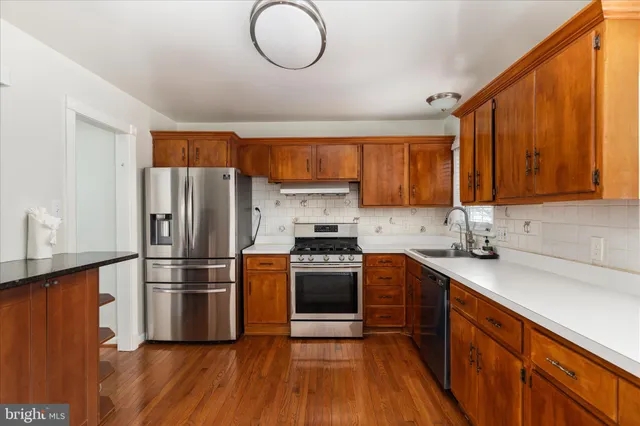 a kitchen with stainless steel appliances granite countertop a stove a sink dishwasher and a refrigerator