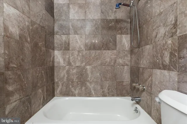 a bathroom with a bathtub and a toilet