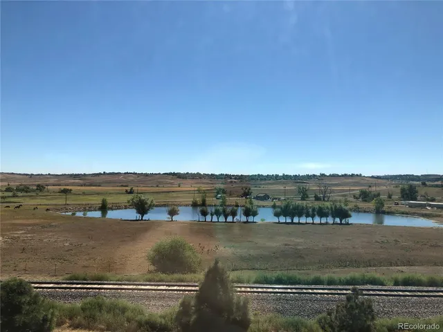 an aerial view of residential houses with outdoor space and ocean view