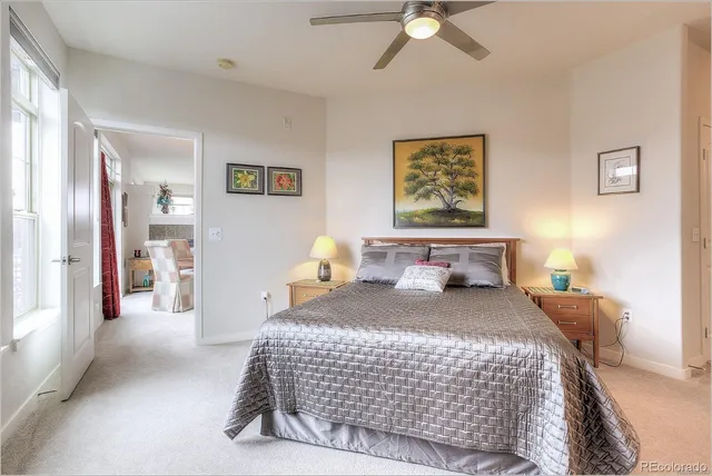 a bedroom with a bed and ceiling fan