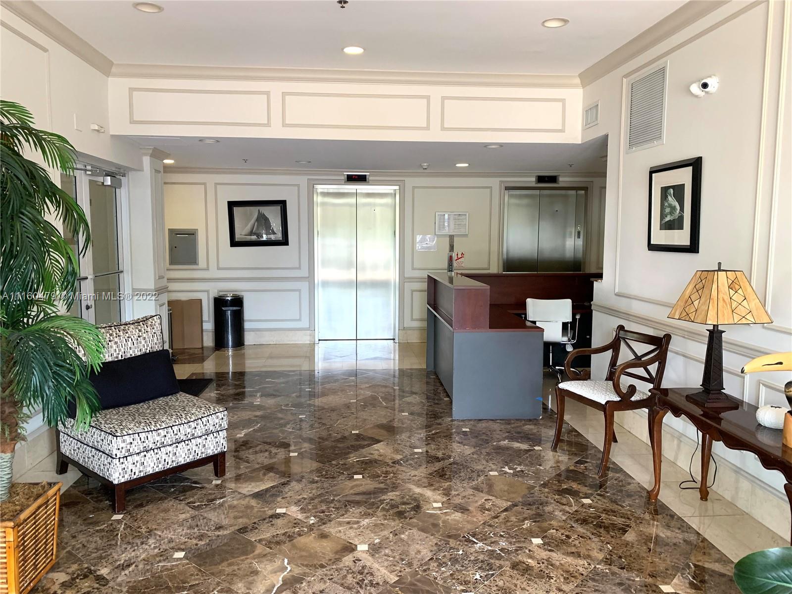 2501 Southwest 37th Avenue, Unit 306 Miami, FL 33133 - Photo 12 of 15 a living room with furniture and a table