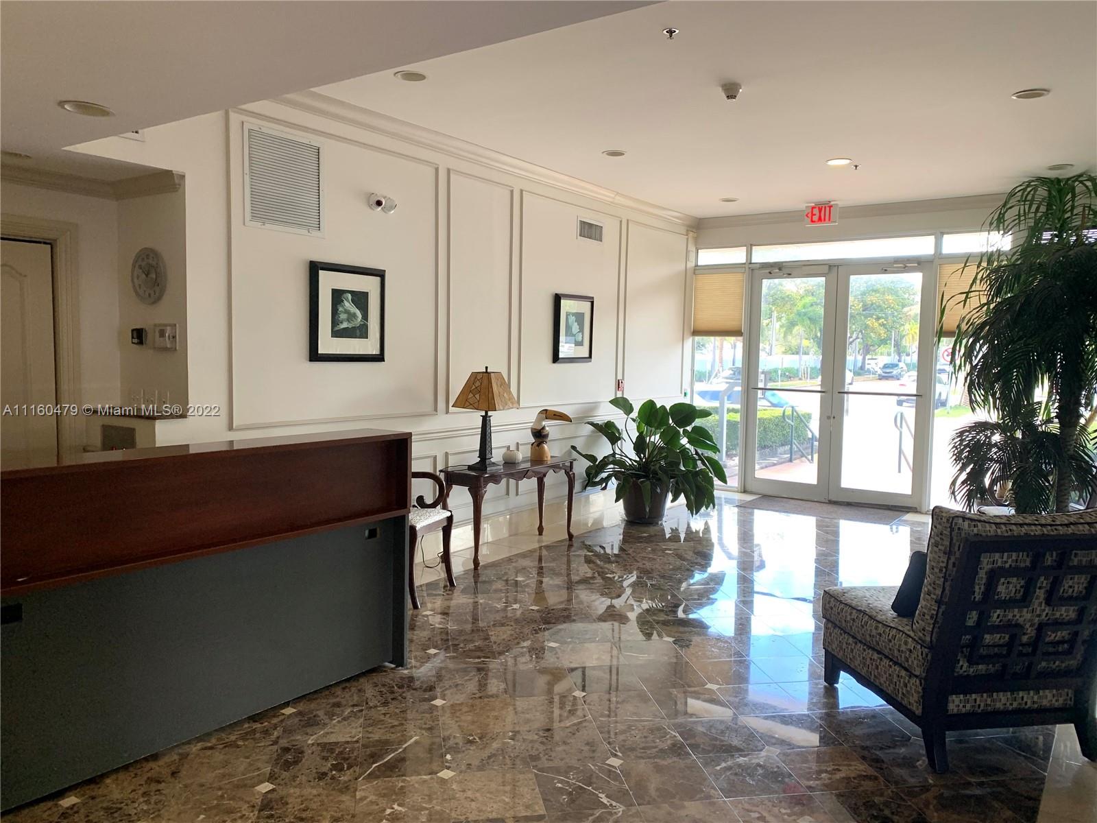 2501 Southwest 37th Avenue, Unit 306 Miami, FL 33133 - Photo 13 of 15 a living room with furniture a window and a potted plant